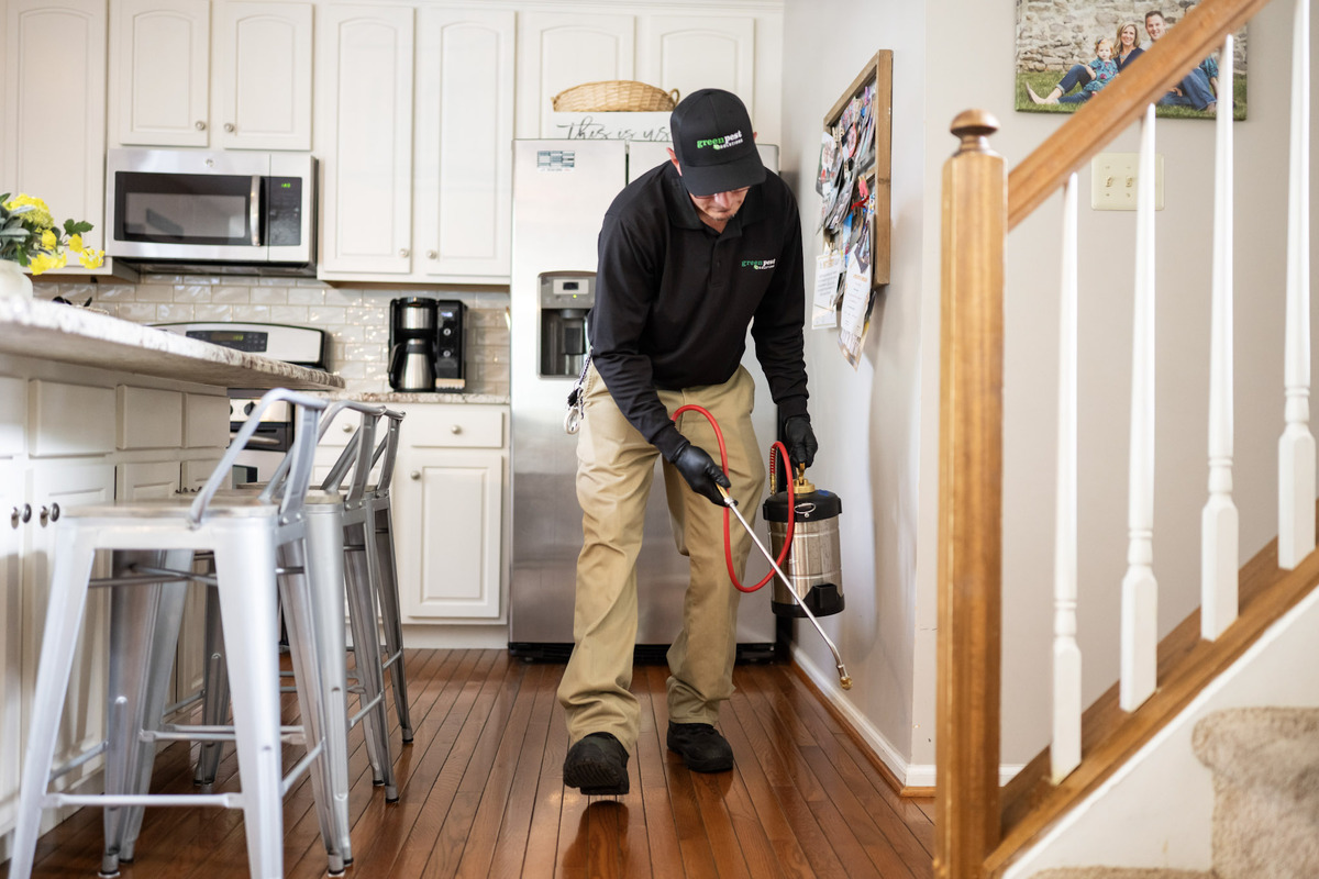 pest control technician servicing a house inside chester county pa-1